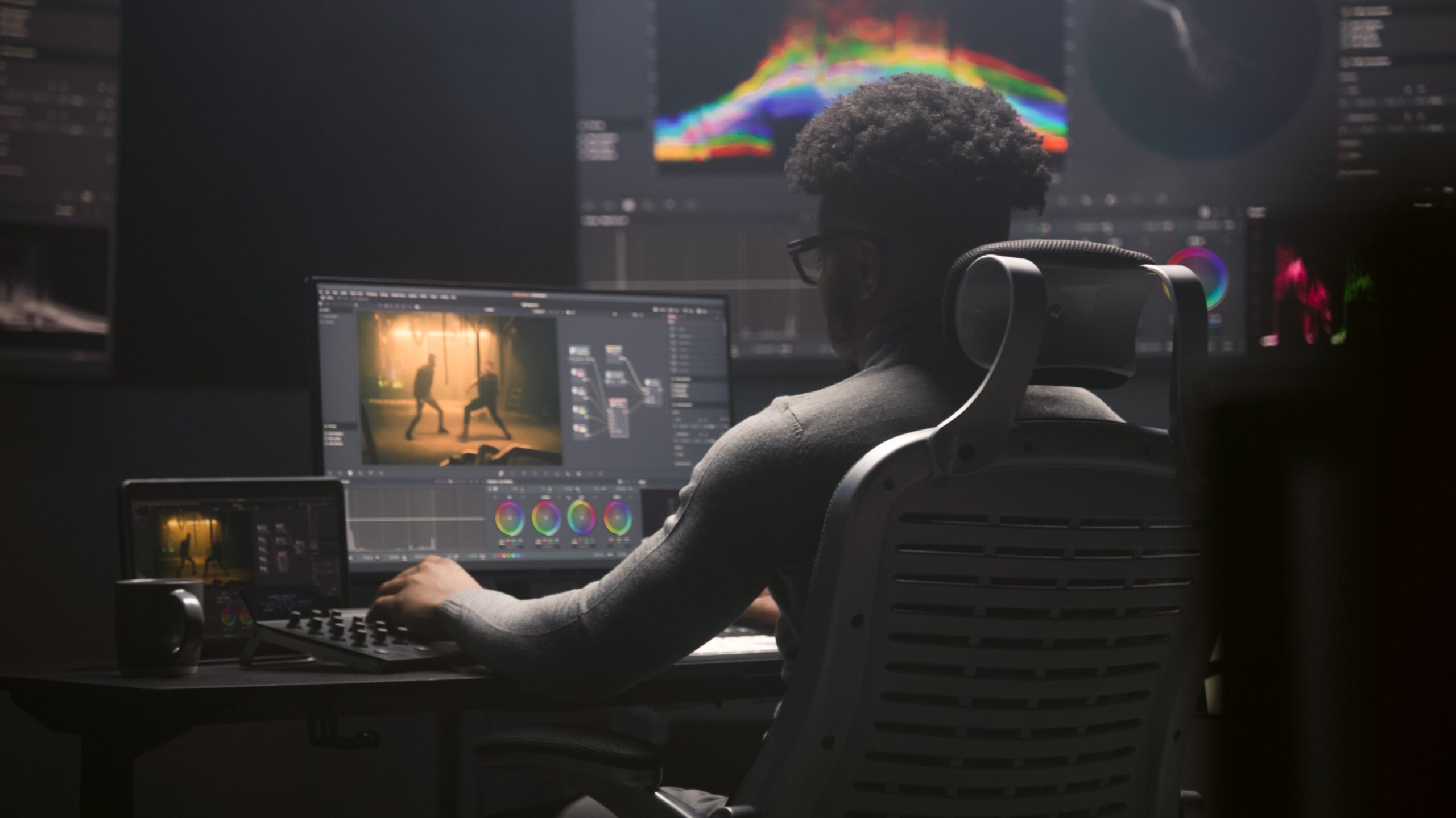Man focused on video editing at a computer, creating compelling and professional videos.