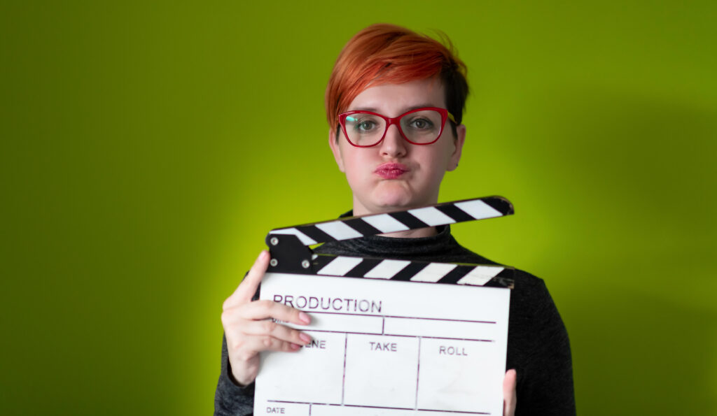 Elevate your brand with expert on Professional Videos. Explore captivating visuals and storytelling excellence, including scenes like a girl standing in front of a green screen, holding a movie clapper at Creative Dynamics.