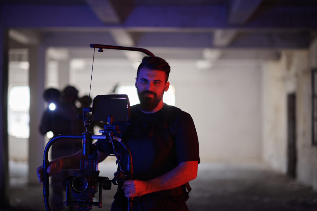 Videographer capturing soldiers in action in an urban environment, specializing in professional videos.